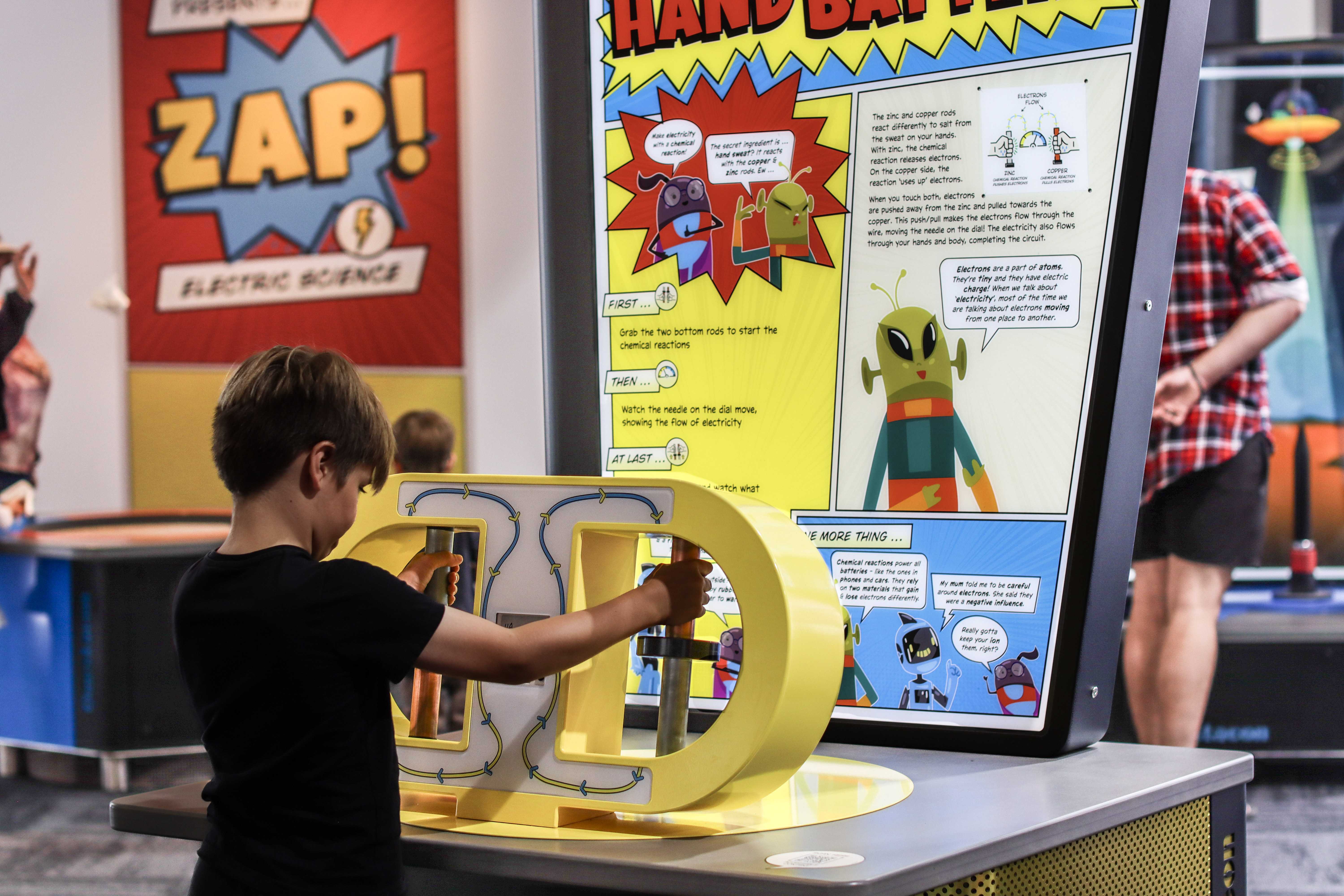 Child using interactive module in the exhibition ZAP Electric Science from Questacon